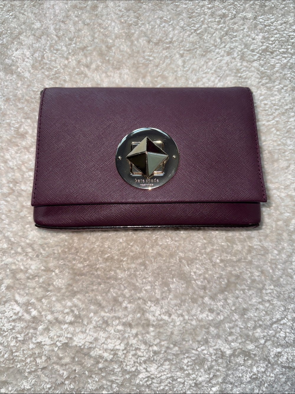 kate spade plum leather flap wallet with polished star emblem